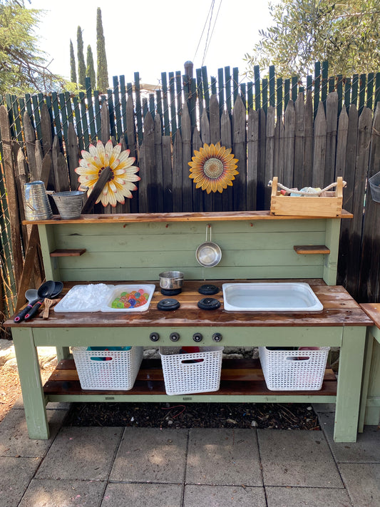Green and redwood mud kitchen with shaving cream and water for sensory play